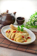 traditional chinese herbal roasted chicken fresh meat roll main course in plate on grey vintage background cafe hotel luxury halal food restaurant banquet menu