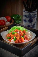 traditional chinese stir fried fat pork ribs roll spicy and sweet sauce meat main course in plate on grey vintage background cafe hotel luxury halal food restaurant banquet menu