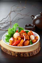 traditional chinese stir fried fat pork ribs roll spicy and sweet sauce meat main course in plate on grey vintage background cafe hotel luxury halal food restaurant banquet menu