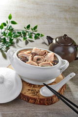 traditional chinese fried braised hot and spicy chilli tomato sauce chicken cutlet meat main course in hot soup clay pot on grey vintage background cafe hotel luxury halal food restaurant banquet menu