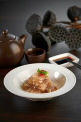 traditional chinese frozen chilled pork fat oil jelly appetiser meat main course in hot soup clay pot on grey vintage background cafe hotel luxury halal food restaurant banquet menu