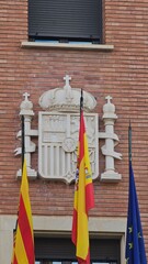 Fototapeta na wymiar Flags of Aragon, Spain and Europe on the facade of the Court of Teruel.