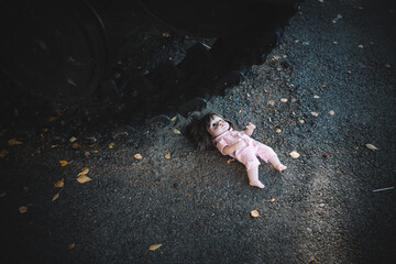 concept of destroying childhood by war. a frightened doll and tank. the concept of suffering of...