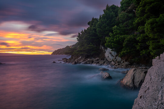 Spectacular landscape of the rocky coastline on the Makarska Riviera during a stormy sunset