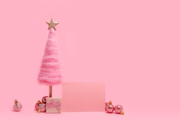 On isolated bright pink background, fluffy, creative wool Christmas tree, greeting card, gift with...