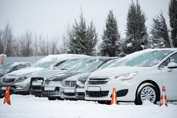 Snow covered parked cars. Winter season.