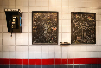 wall with old telephone and blackboard