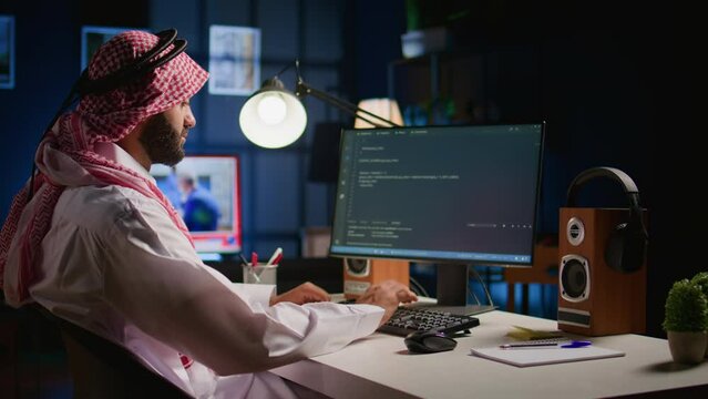 Technician writing script code on computer screen using Java programming languages for outsourced project. Teleworking employee at home fixing intranet database errors, handheld camera shot