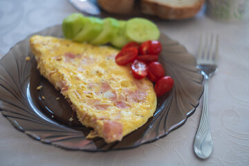 Excellent breakfast. Egg omelette with vegetables - tomato and cucumber.