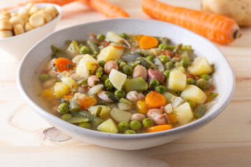 Vegetable and legume minestrone served with croutons. Complete vegan dish ideal for lunch and dinner. Italian minestrone.