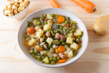 Vegetable and legume minestrone served with croutons. Complete vegan dish ideal for lunch and dinner. Italian minestrone.