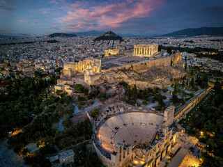 Aerial view of illuminated, ancient ruins at the Acropolis of Athens, Greece, and Odeon of Herode...