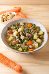 Vegetable and legume minestrone served with croutons. Complete vegan dish ideal for lunch and dinner. Italian minestrone.