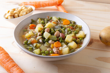 Vegetable and legume minestrone served with croutons. Complete vegan dish ideal for lunch and dinner. Italian minestrone.