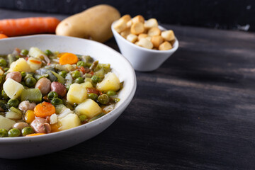 Vegetable and legume minestrone served with croutons. Complete vegan dish ideal for lunch and dinner. Italian minestrone.