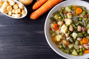 Vegetable and legume minestrone served with croutons. Complete vegan dish ideal for lunch and dinner. Italian minestrone.