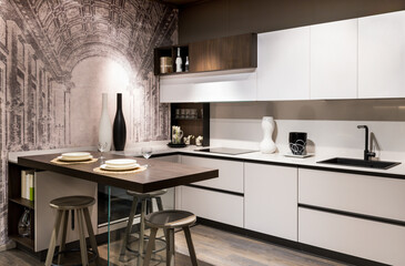 Modern kitchen interior with built in appliances and dining table