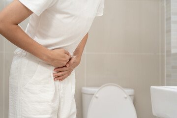 Constipation and diarrhea in bathroom. Hurt woman touch belly  stomach ache painful. colon...