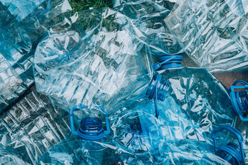 Top view of empty rumpled used blue plastic bottles background