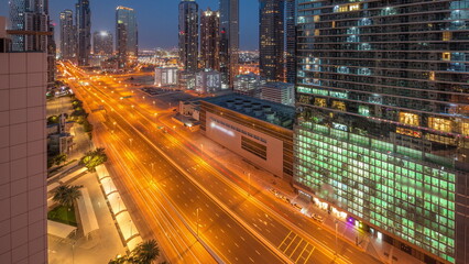 Fototapeta premium Business bay district skyline with modern architecture night to day timelapse from above.