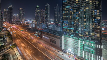 Panorama showing business bay district skyline with modern architecture night timelapse from above.
