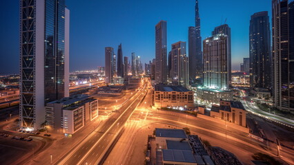 Fototapeta na wymiar Aerial view of Dubai Downtown skyline with many towers night to day timelapse.