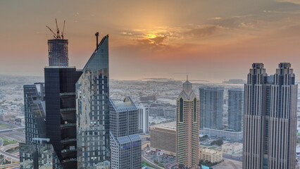 High-rise buildings on Sheikh Zayed Road in Dubai aerial timelapse during sunset, UAE.