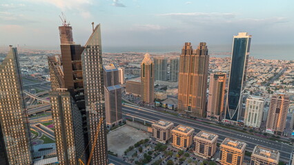 Obraz premium High-rise buildings on Sheikh Zayed Road in Dubai aerial morning timelapse, UAE.