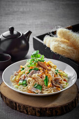 traditional chinese wok stir fried bee hoon noodle mee goreng with clam prawn seafood in plate on grey vintage background cafe hotel luxury halal food restaurant banquet menu