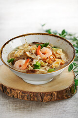 traditional chinese healthy braised puritan noodle with clam prawn seafood thick soup in bowl on grey vintage background cafe hotel luxury halal food restaurant banquet menu