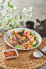 traditional chinese wok stir fried bee hoon noodle mee goreng with clam prawn seafood in plate on grey vintage background cafe hotel luxury halal food restaurant banquet menu