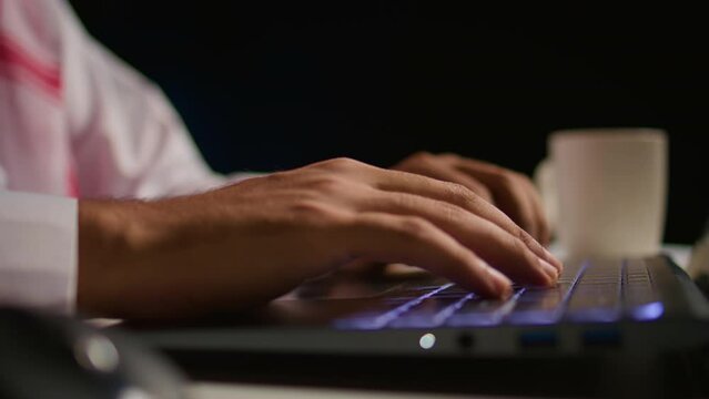 Close up shot of businessman using laptop keyboard and touchpad in office to send emails. Business executive typing on notebook, composing documents in order to deliver finalized project paperwork