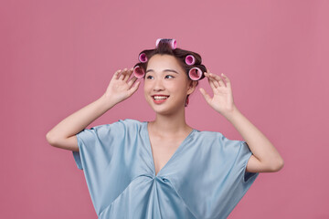 Portrait of young woman wearing hair rollers