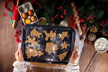 Cooking Christmas cookies family background. Mother and daughter hands top view on cozy wooden...