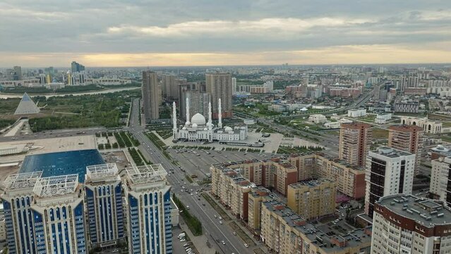 Hazrat Sultan Mosque Next To Kazakh Eli Square At Sunset In Astana, Kazakhstan. aerial sideways