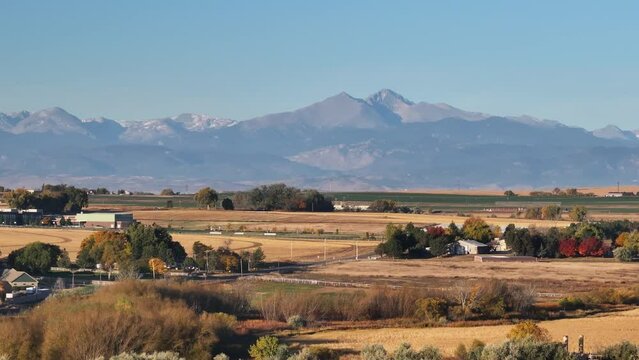 Longs peak colorado fourteen thousand feet mountain towering above the surrounding farms and fields.