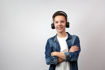Portrait of teenage boy with headphones over white background