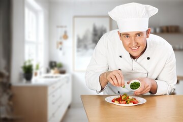 A professional chef creates food at kitchen