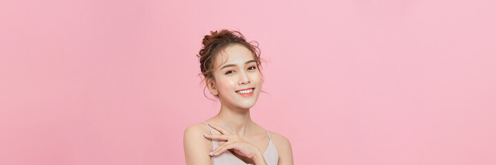 Portrait of attractive asian girl with beauty natural skin isolated on pink background