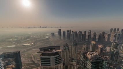 Panorama of Dubai Marina with JLT skyscrapers and golf course during sunrise timelapse, Dubai, United Arab Emirates.