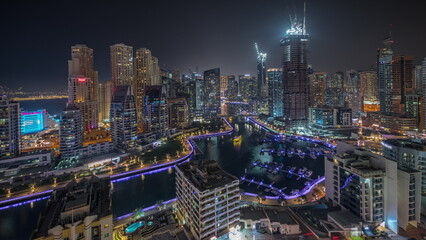Fototapeta na wymiar Panorama showing Dubai Marina skyscrapers and JBR district with luxury buildings and resorts aerial night timelapse