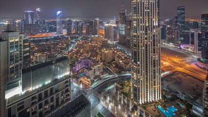 Panorama showing aerial view of a big futuristic city night timelapse. Business bay and Downtown