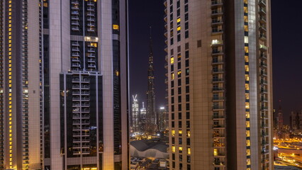 Tallest skyscrapers in downtown dubai located on bouleward street near shopping mall aerial all night timelapse.