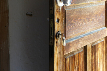 classic village house stands with key on the door and lock,