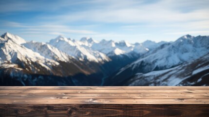 Close up of a top wooden table with snowy mountains background.