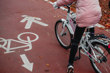 A girl rides along a bike path