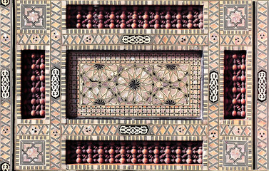 Detail of ancient mosaic window shutter with mother-of-pearl and wood ornaments. Horizontal or...
