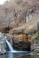 A small waterfall in the middle of the forest. natural pool and waterfall. River and rocks