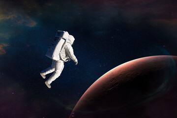 Obraz na płótnie Canvas Astronaut in outer space close to Mars planet. Elements of this image furnished by NASA.
