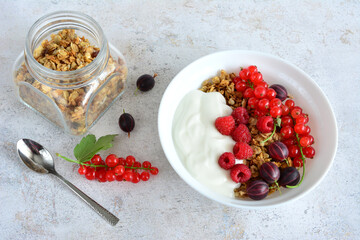muesli with yogurt and fresh berries in bowl top table view   